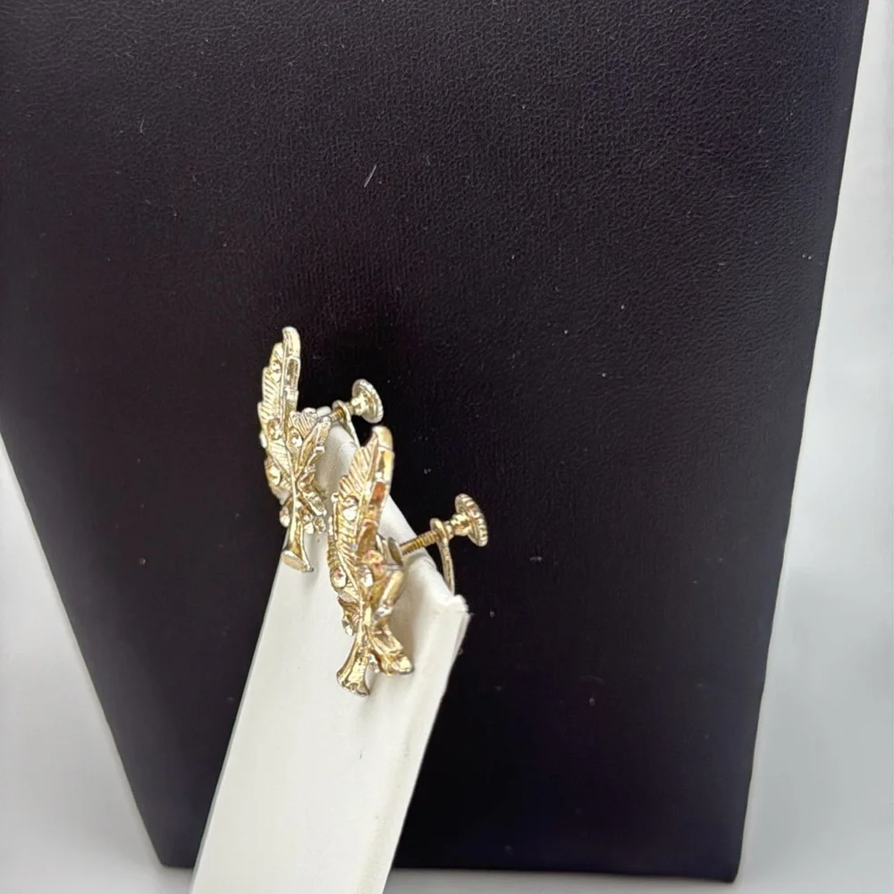 Gold tone textured leaf rhinestone accent screw back statement earrings